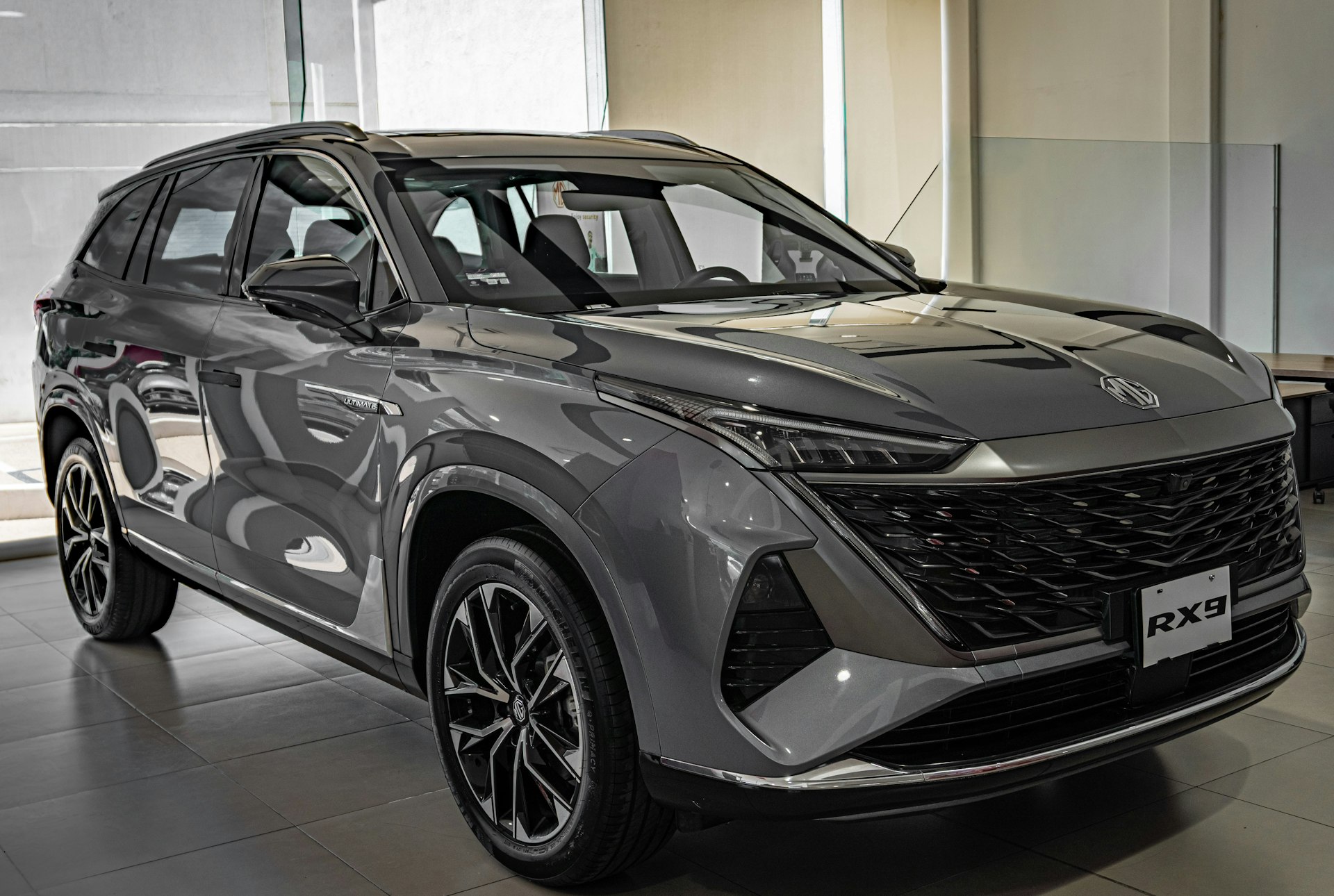 A modern grey suv parked indoors.